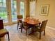 Inviting dining area with wood table, patterned chairs, and large windows offering a bright view at 3083 Pinnacle Ct, Clermont, FL 34711