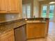 Bright kitchen with a stainless steel dishwasher and granite countertops at 3083 Pinnacle Ct, Clermont, FL 34711