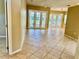 Bright living room with tile floors and natural light from the French doors at 3083 Pinnacle Ct, Clermont, FL 34711