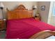 Comfortable bedroom featuring a large wood bed frame and bedside tables at 3083 Pinnacle Ct, Clermont, FL 34711