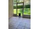 Screened patio showing tile flooring, backyard views, and a convenient pet door at 3083 Pinnacle Ct, Clermont, FL 34711