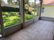 Spacious screened lanai featuring tile flooring, offering serene backyard views at 3083 Pinnacle Ct, Clermont, FL 34711