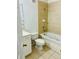 Bright bathroom with a shower-tub combo, beige tile, and a white vanity at 3107 Sun Lake Ct # A, Kissimmee, FL 34747