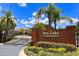 Entrance to Sun Lake Condominiums features a brick sign and manicured landscaping at 3107 Sun Lake Ct # A, Kissimmee, FL 34747