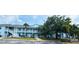 Inviting two-story condo building with a blue exterior, balconies, and mature landscaping at 3107 Sun Lake Ct # A, Kissimmee, FL 34747