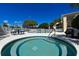 Relaxing hot tub surrounded by lounge chairs and manicured landscaping at 3107 Sun Lake Ct # A, Kissimmee, FL 34747