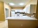 Bright kitchen with a breakfast bar, white cabinets, and modern appliances at 3107 Sun Lake Ct # A, Kissimmee, FL 34747