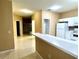 View of kitchen that has white cabinets, white appliances and a tile floor at 3107 Sun Lake Ct # A, Kissimmee, FL 34747