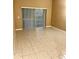 Living room with a sliding glass door, beige color, and a tile floor at 3107 Sun Lake Ct # A, Kissimmee, FL 34747