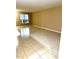 Open living room offering tile floors and ample natural light streaming through a large window at 3107 Sun Lake Ct # A, Kissimmee, FL 34747