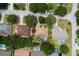 Aerial view of a property with mature trees, a screened-in pool, and a lush, well-maintained lawn at 3141 Brighton Rd, Eustis, FL 32726