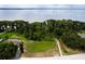Aerial view showing a green space leading to a lake, with houses and trees dotting the landscape at 3141 Brighton Rd, Eustis, FL 32726