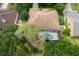 Aerial view of a property with a screened-in pool, mature trees, and a well-maintained lawn in a residential area at 3141 Brighton Rd, Eustis, FL 32726