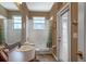 Bright bathroom features a shower-tub combo with a single sink vanity and door to outside at 3141 Brighton Rd, Eustis, FL 32726
