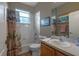 Bright bathroom featuring a shower-tub combo, a white vanity and a patterned shower curtain at 3141 Brighton Rd, Eustis, FL 32726
