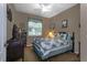 This bedroom includes a ceiling fan, carpet flooring, a window with blinds, and a bookcase at 3141 Brighton Rd, Eustis, FL 32726