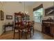 Elegant dining room with a chandelier, a wooden dining set, and a china cabinet at 3141 Brighton Rd, Eustis, FL 32726
