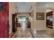 Inviting foyer with tile flooring, grand grandfather clock, and views of the living room at 3141 Brighton Rd, Eustis, FL 32726