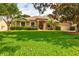 Charming single-story home with lush green lawn and beautifully landscaped front yard at 3141 Brighton Rd, Eustis, FL 32726