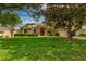 Landscaped single-story home with manicured lawn, palm trees, and charming stone accents at 3141 Brighton Rd, Eustis, FL 32726