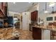 Modern kitchen with stainless steel appliances, granite countertops, tile floors, and a breakfast bar at 3141 Brighton Rd, Eustis, FL 32726