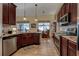 Kitchen with stainless steel appliances, granite counters, dark wood cabinets, and a breakfast nook at 3141 Brighton Rd, Eustis, FL 32726