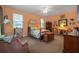 Spacious main bedroom with carpet flooring, a ceiling fan, and large windows with blinds at 3141 Brighton Rd, Eustis, FL 32726