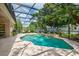 Beautiful screened-in pool area with tropical landscaping, perfect for relaxing and enjoying the Florida lifestyle at 3141 Brighton Rd, Eustis, FL 32726