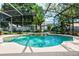 Stunning screened-in pool with beautiful landscaping and small water feature offers a private outdoor retreat at 3141 Brighton Rd, Eustis, FL 32726