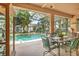 Relaxing outdoor living space boasts a screened pool and outdoor dining area surrounded by lush landscaping at 3141 Brighton Rd, Eustis, FL 32726