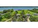 Stunning aerial view of waterfront property with manicured lawns, mature trees, and lake access at 33637 E Lake Joanna Dr, Eustis, FL 32736