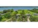 Expansive waterfront property, featuring manicured lawns and mature trees, showcased in a scenic aerial view at 33637 E Lake Joanna Dr, Eustis, FL 32736