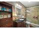 Elegant bathroom with a glass-enclosed shower, modern vanity, and decorative elements at 33637 E Lake Joanna Dr, Eustis, FL 32736