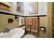 Vintage-style bathroom with yellow tiling, black accents, and classic fixtures at 33637 E Lake Joanna Dr, Eustis, FL 32736