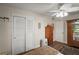 Bright bedroom with a closet, wooden dresser and a decorative ceiling fan at 33637 E Lake Joanna Dr, Eustis, FL 32736
