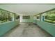 Covered carport area featuring a window and adjacent entry door at 33637 E Lake Joanna Dr, Eustis, FL 32736