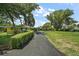 Long driveway leading to a home with mature trees and well-maintained landscaping at 33637 E Lake Joanna Dr, Eustis, FL 32736