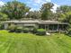 Lush lawn and well-kept landscaping surround this home, highlighting its outdoor appeal at 33637 E Lake Joanna Dr, Eustis, FL 32736