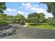 Charming single-story home with a well-manicured lawn and covered carport, nestled among mature trees at 33637 E Lake Joanna Dr, Eustis, FL 32736