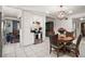 Bright kitchen and breakfast nook featuring white cabinetry, stainless steel appliances and wicker dining chairs at 33637 E Lake Joanna Dr, Eustis, FL 32736