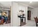 Kitchen area featuring white cabinetry, stainless steel appliances and tile flooring, open to the living room at 33637 E Lake Joanna Dr, Eustis, FL 32736