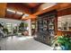 Elegant living area with tile floors, wood-paneled walls, skylights, and a display case full of collectibles at 33637 E Lake Joanna Dr, Eustis, FL 32736