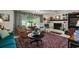 Cozy living room featuring a brick fireplace, comfortable seating, and a large window with water views at 33637 E Lake Joanna Dr, Eustis, FL 32736