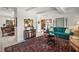 Bright living room features tile floor, a brick pillar, decorative accents, and an ornate area rug at 33637 E Lake Joanna Dr, Eustis, FL 32736