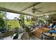 Spacious screened patio filled with lush plants and comfortable seating, overlooking the yard at 33637 E Lake Joanna Dr, Eustis, FL 32736