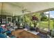 Relaxing sunroom featuring ceiling fans and beautiful views of the landscaped backyard at 33637 E Lake Joanna Dr, Eustis, FL 32736