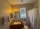 Cozy bathroom with a vanity, mirror, and shower with curtain at 33818 Venice Ln, Sorrento, FL 32776