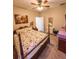 Cozy bedroom with carpeted floors, a decorative painting, and a ceiling fan at 33818 Venice Ln, Sorrento, FL 32776
