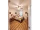 Bedroom with a ceiling fan, a traditional-style bed, a wood nightstand, and wood-look laminate floors at 33818 Venice Ln, Sorrento, FL 32776