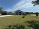 Charming home with a well-manicured lawn, complemented by a two-car garage and attractive curb appeal at 33818 Venice Ln, Sorrento, FL 32776
